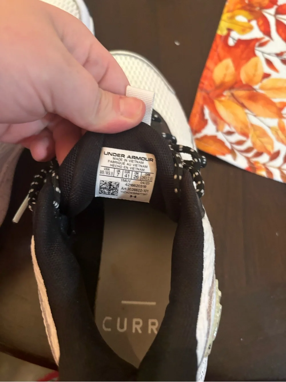 Under Armour Women's White and Black Athletic Sneakers with Gold Detail